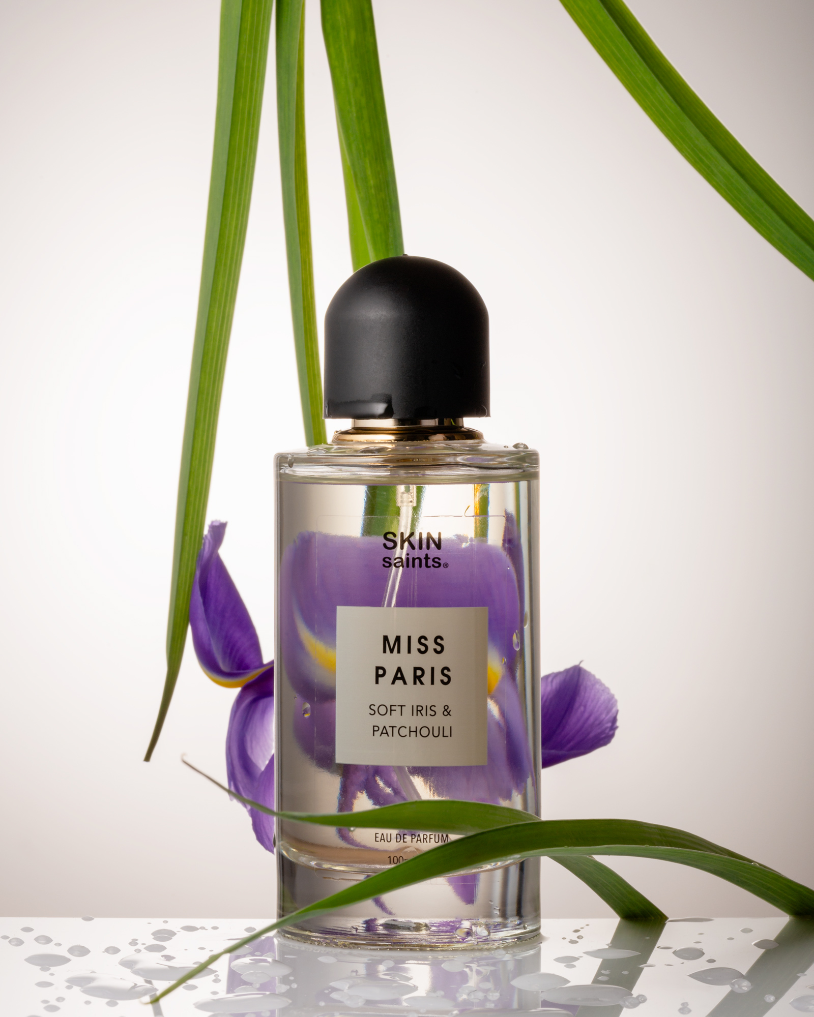Perfume with refraction of an iris, seen through the glass