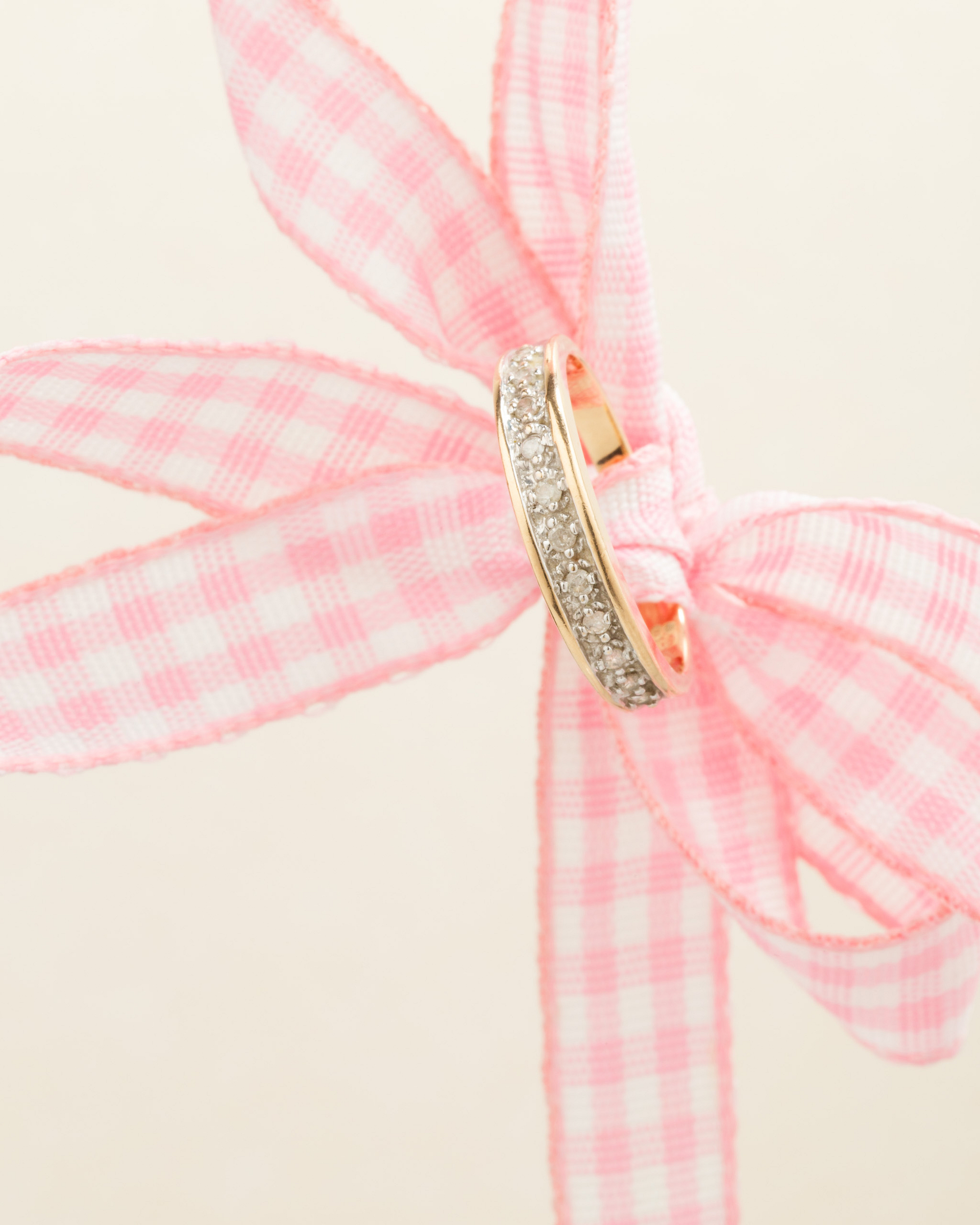 Diamond ring on a ribbon.