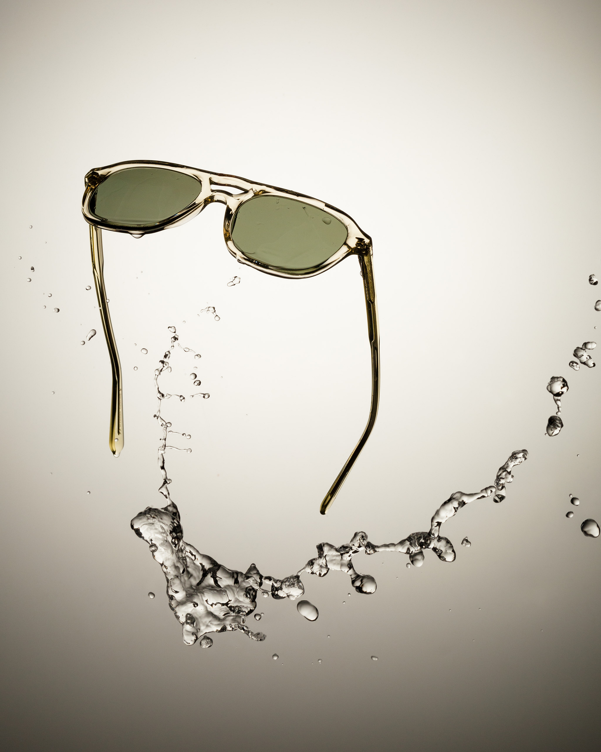 Flying sunglasses with a water splash.