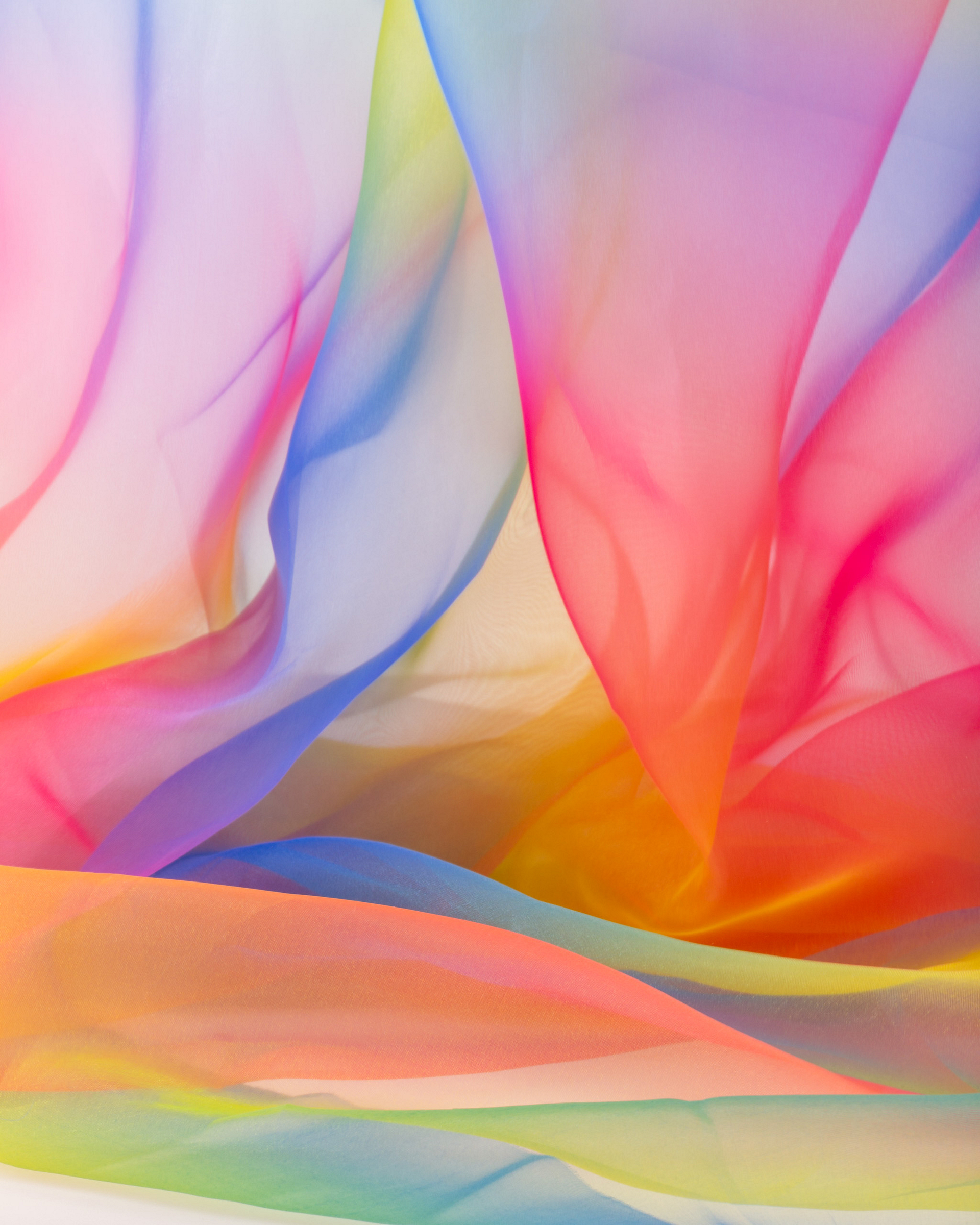 Rainbow-coloured fabric against a light background.
