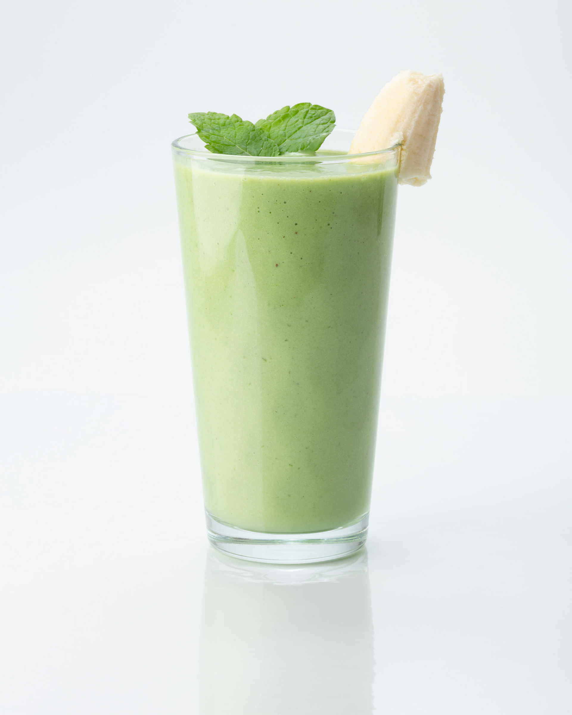 A green smoothie on a light background.