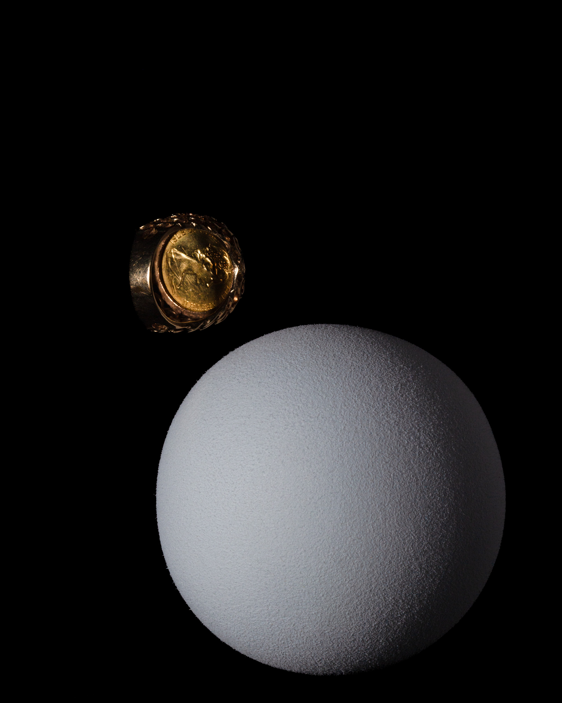 Sovereign ring with a sphere on a dark background.