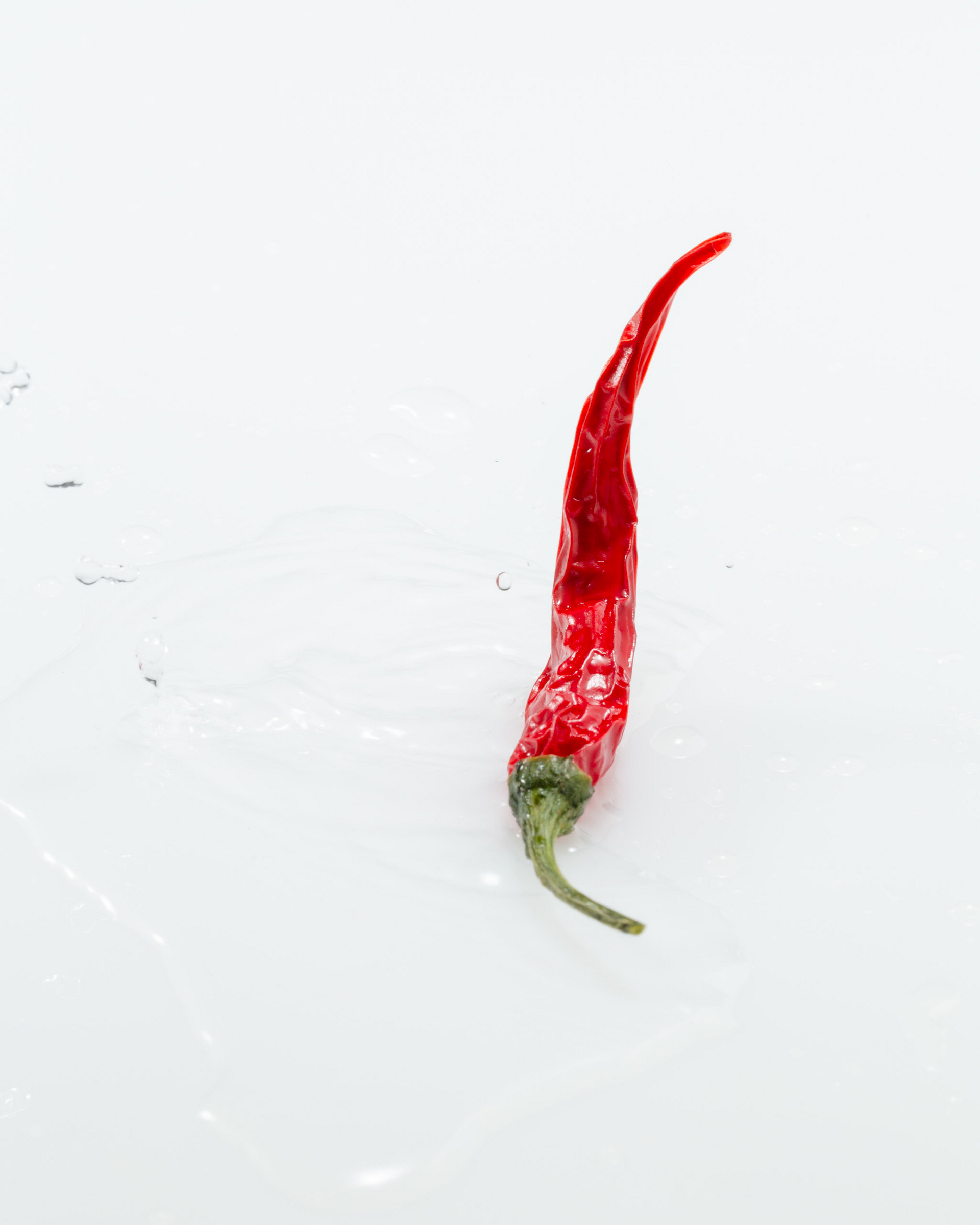 Red chili pepper on a light background.