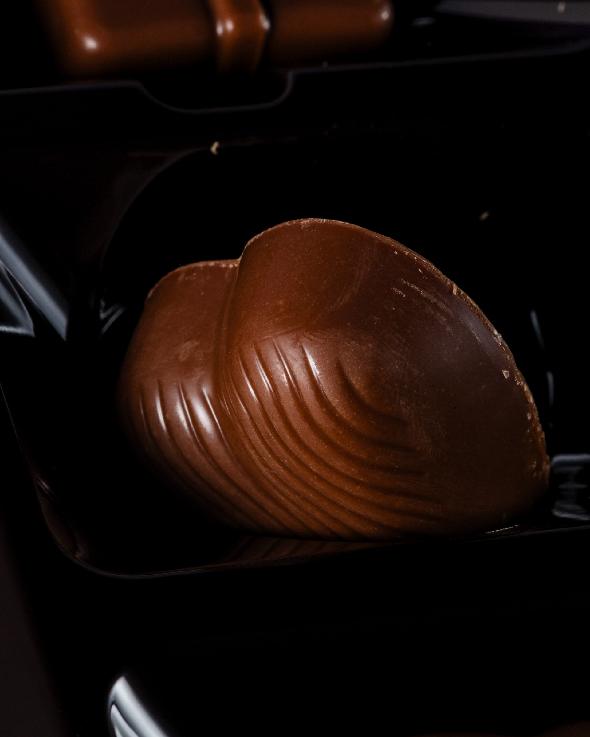 Close-up of a heart-shaped chocolate praline.