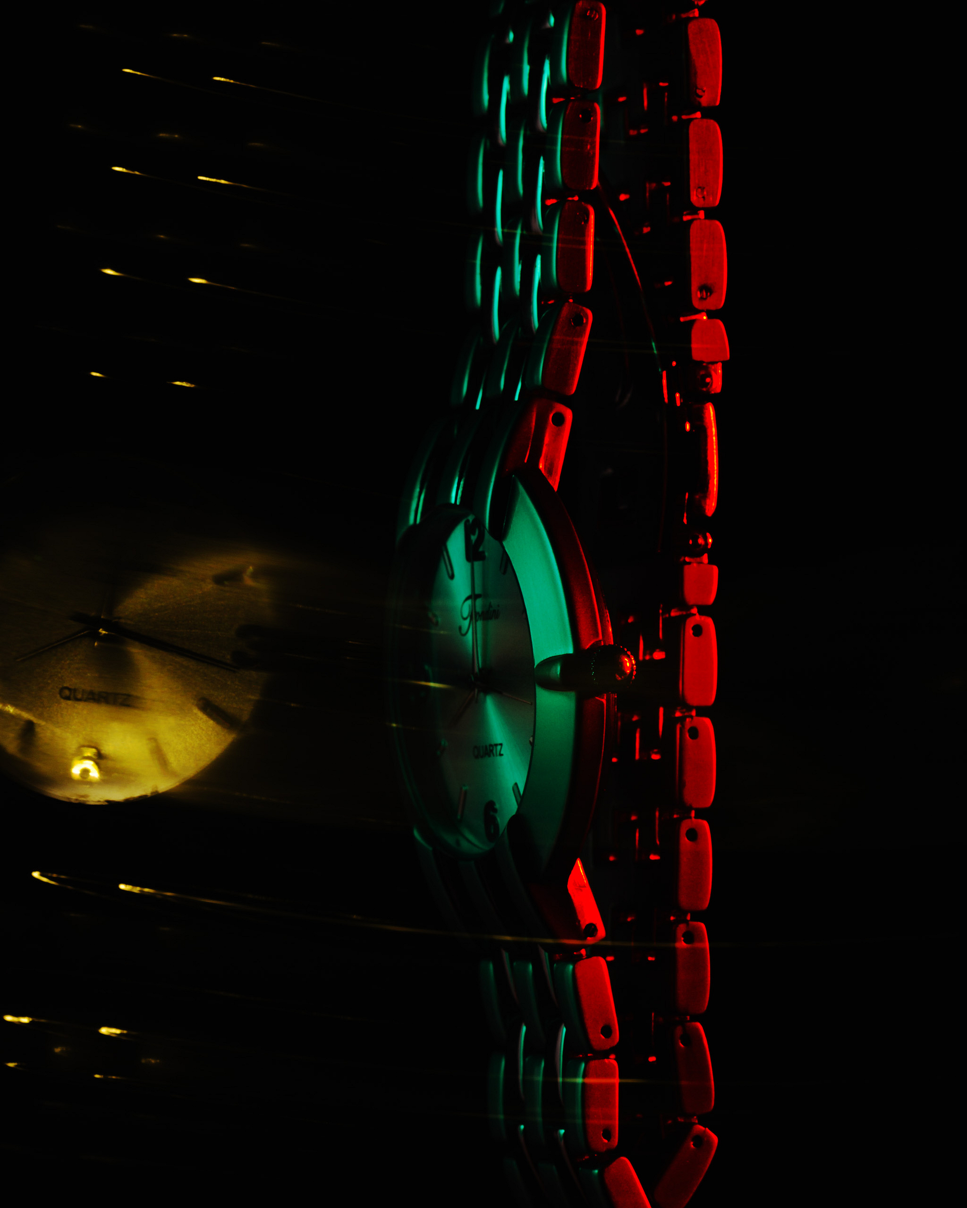 A reflecting watch on a dark background.